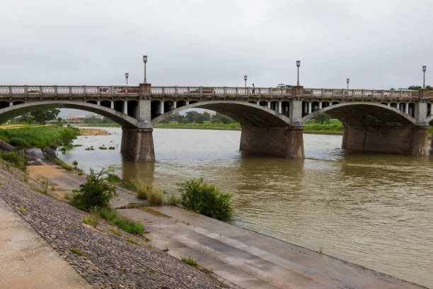 istock Flooded river and old bridge 1257697800