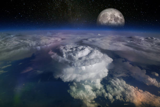 istock Landscape from space, with huge hurricane birth clouds and starry sky and moonrise. Elements of this image furnished by NASA. 1257700156