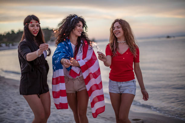 istock Female friends on a Beach party at sunset 1257704400