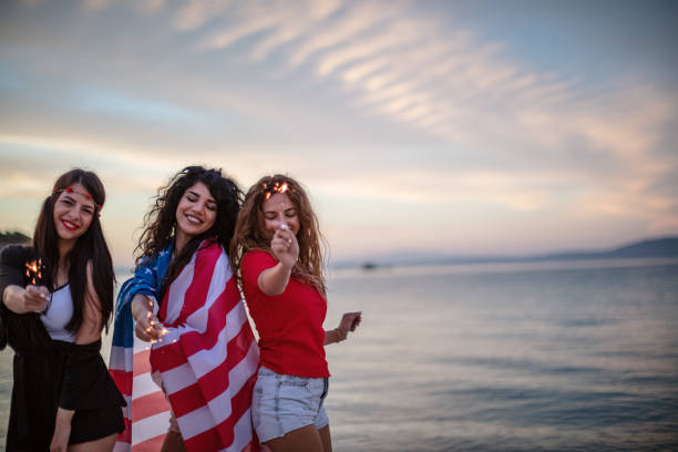 istock Female friends on a Beach party at sunset 1257704484