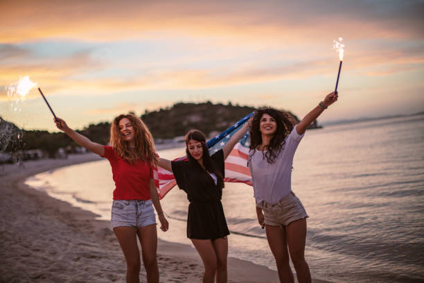 istock Friends with fireworks on a beach after sunset 1257705404