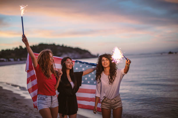 istock Friends with fireworks on a beach after sunset 1257705427