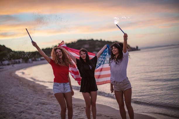 istock Friends with fireworks on a beach after sunset 1257705474