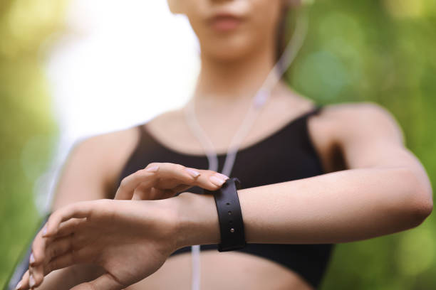 istock Gadgets For Sport. Female athlete using smartwatch outdoors to track training progress 1257705475