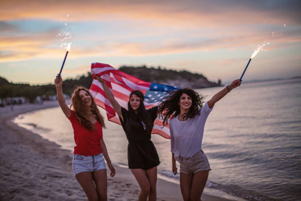 istock Friends with fireworks on a beach after sunset 1257705496