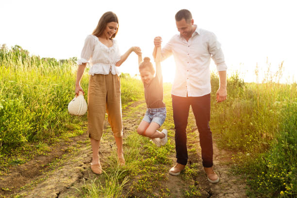 istock Happy parents and kid walking together in summer 1257705592