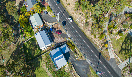 Aerial view of country Tasmanian town houses with passing traffic