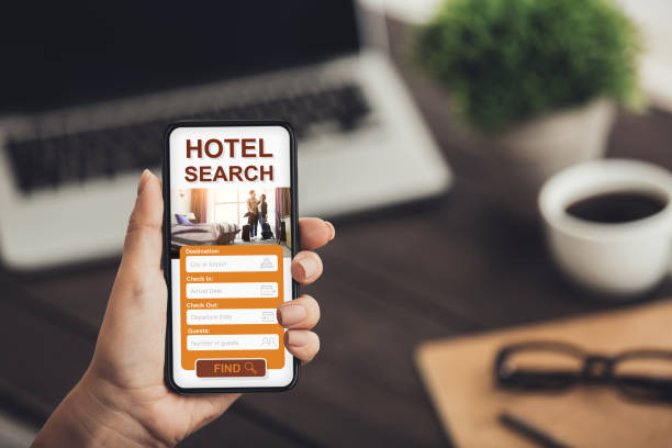 istock Woman using mobile app for hotel booking, office interior 1257706570
