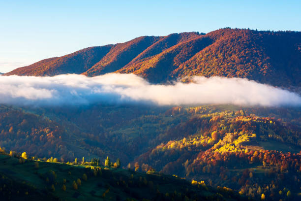 istock autumn sunset in mountains 1257707598