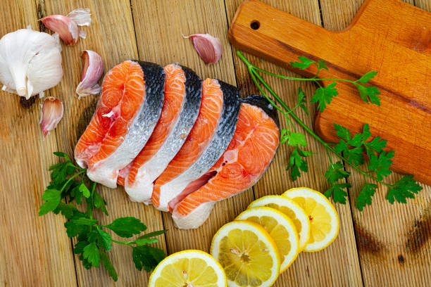 istock Fresh raw salmon fillet on wooden table 1257709066