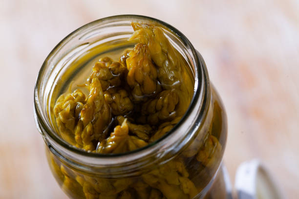 istock Glass jar with pickled asparagus on a wooden table 1257709087