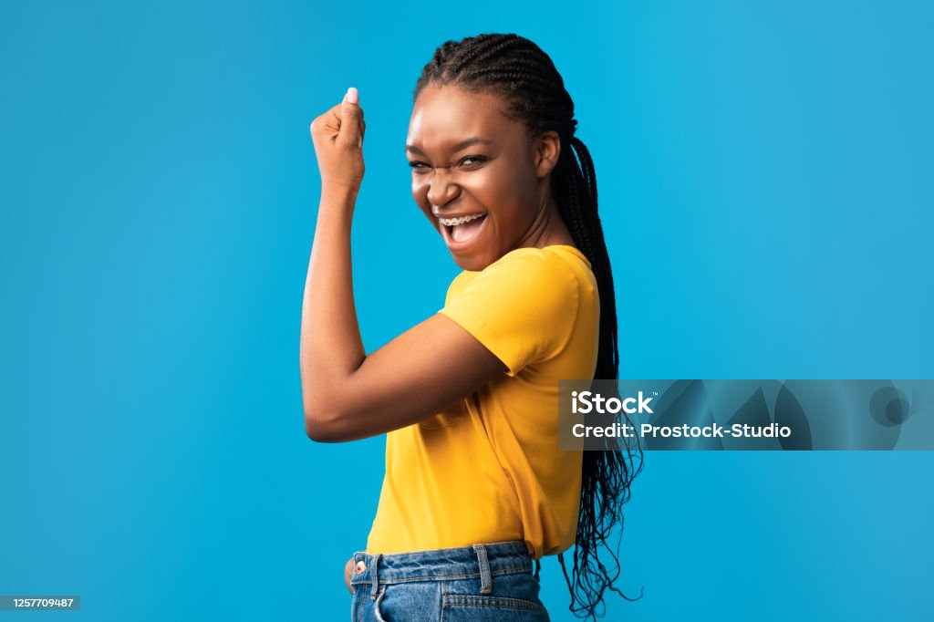 Joyful African American Girl Gesturing Yes Posing Over Blue Background  Stock Photo - Download Image Now - iStock