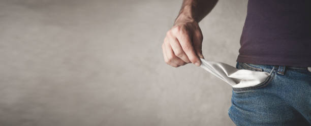 istock Man showing empty pocket. Bankruptcy. No money 1257709512
