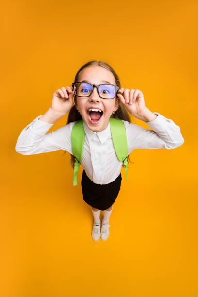 istock Nerdy Schoolgirl Looking Through Eyeglasses In Excitement, Studio, High-Angle Shot 1257709822