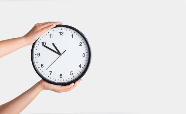 istock Time management. Female hands holding clock on white background, closeup. Copy space 1257710201