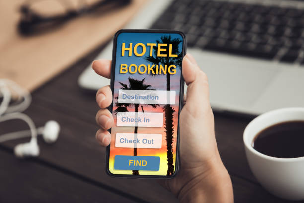 istock Female hand holding mobile phone with booking application 1257710563
