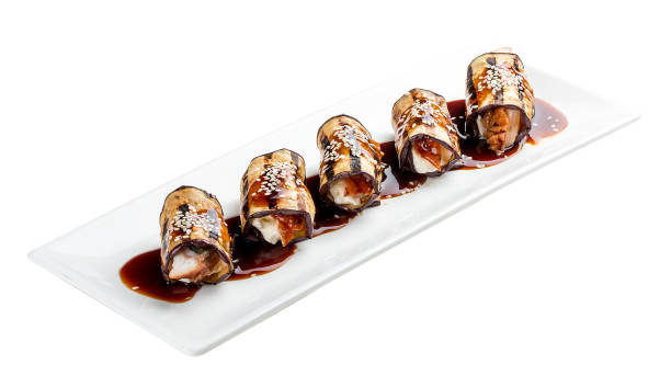 istock Eggplant rolls stuffed with Philadelphia cheese and eel. On white background. 1257712048