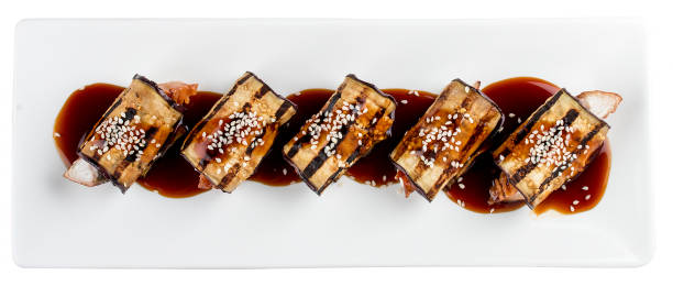 istock Eggplant rolls stuffed with Philadelphia cheese and eel. On white background. 1257712061
