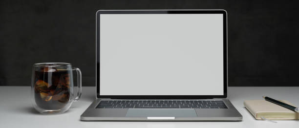 istock Working table with laptop, coffee mug and stationery on white table, clipping path. 1257712918