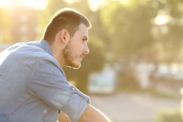 istock Pensive man contemplating looking away on a balcony 1257713551