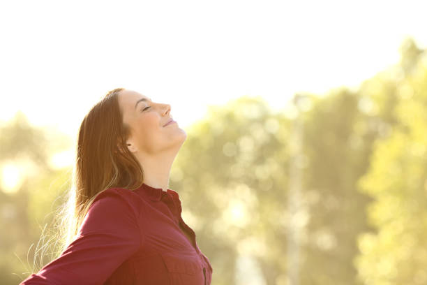 istock Relaxed woman breathing fresh air outdoors on a park 1257713562