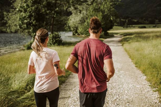 istock Young couple running in nature 1257713906