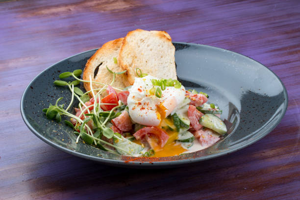 istock Homemade salad with vegetables and poached egg. Breakfast. 1257714748