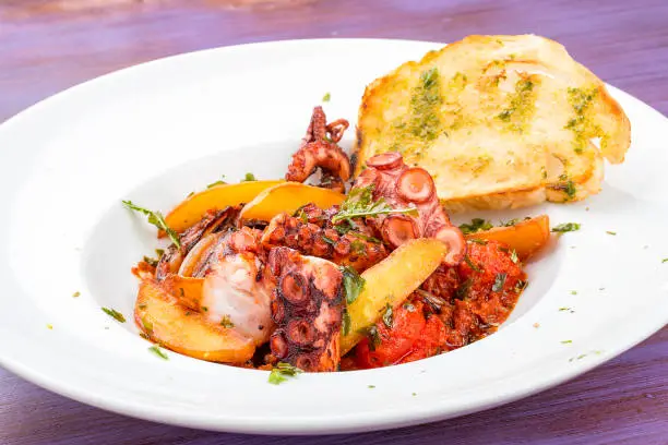 Italian-style fried octopus with tomatoes and potatoes