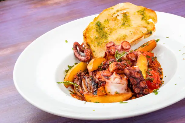 Italian-style fried octopus with tomatoes and potatoes