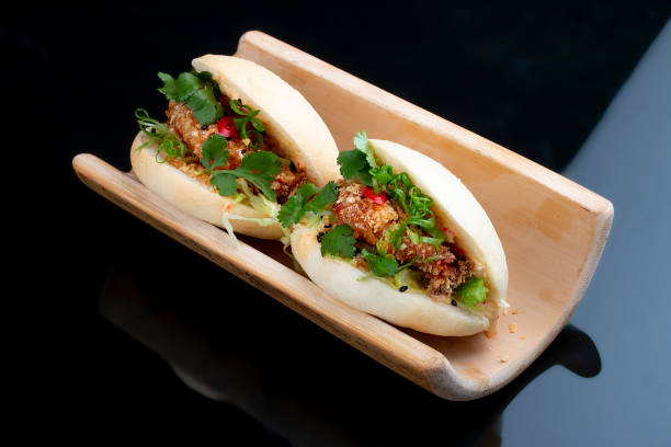 istock Bao. Steamed rice rolls with shrimp and herbs.  On a black background. Vegetarian dish. 1257715075