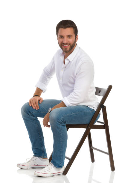 istock Cheerful Handsome Man Is Sitting On A Chair. 1257715963