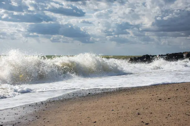 Photo of Big waves roll up on the beach