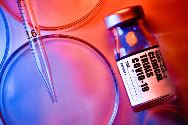Covid-19 Clinical Trials: vials and petri dishes on white table