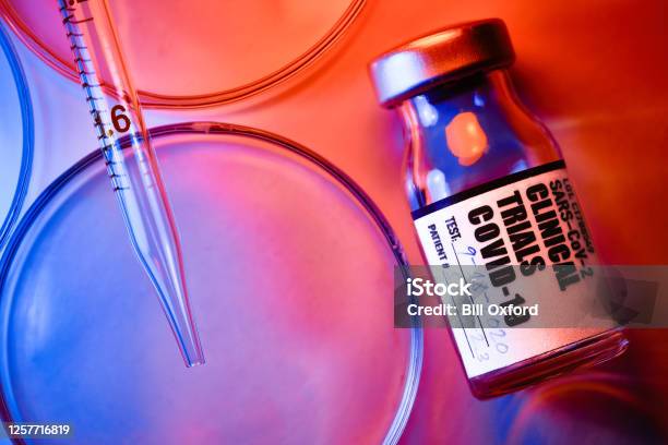 Covid19 Clinical Trials Vials And Petri Dishes On White Table Stock Photo - Download Image Now