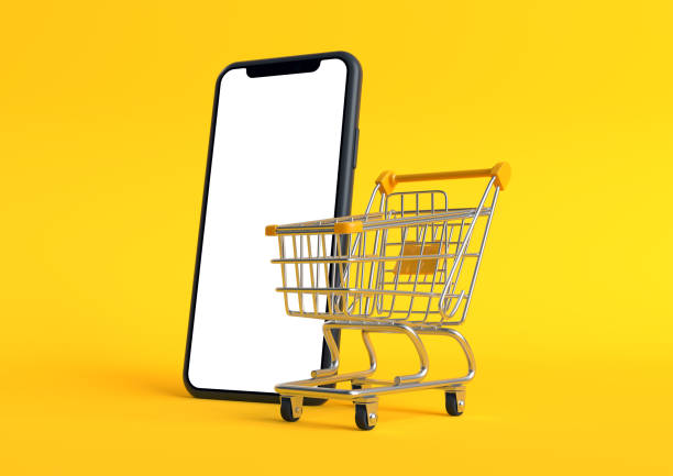 Shopping cart with empty smartphone screen on a yellow background