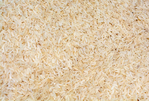 istock Pile of brown color rice texture background. 1257721606