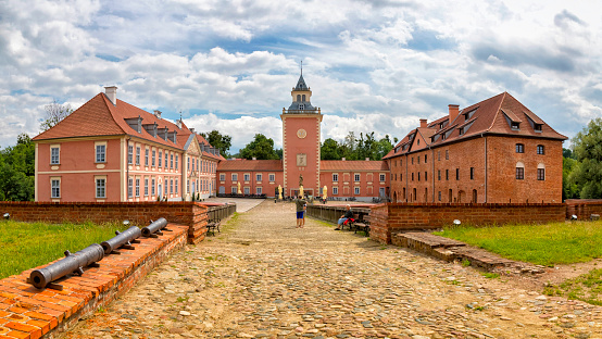 Lidzbark Warminski, Poland - July 01, 2020:Lidzbark Bishops' Castle, is a gothic fortified castle and palace built between 1350-1401 as the seat of the Warmian bishops, later going into the hands of the Teutonic Order. The castle is located in the town of Lidzbark Warmiński, Warmian-Masurian Voivodeship, Poland. View of the southern part of the bailey converted into a hotel