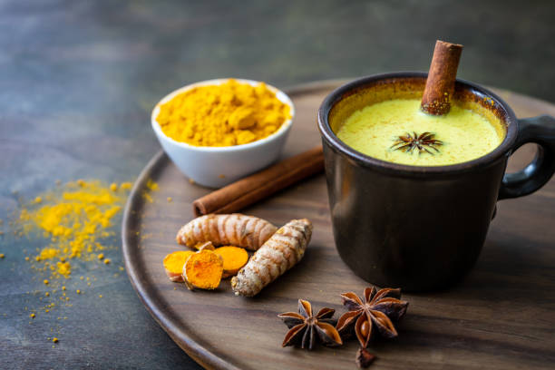 Golden milk with turmeric in a brown cup, close-up