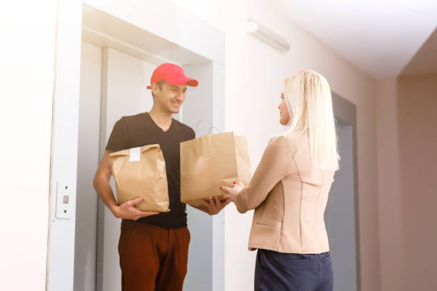 istock A handsome young delivery man delivering a package to apartment 1257722962