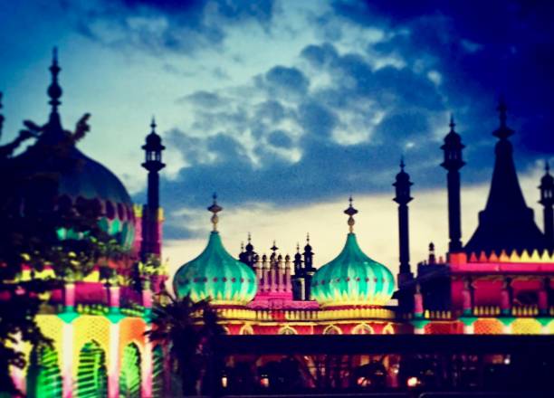 Brighton Pavilion was lit up in rainbow colours during Brighton festival, photo taken in the evening as the sun sets on May 28 2016.Backdrop of cloudy, blue skies