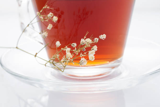 istock Black tea in a glass cup on a white background 1257726691