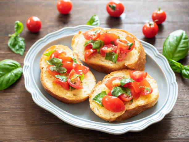 istock Tomato and Basil Bruschetta on blue plate 1257728163