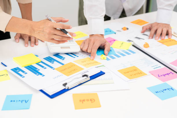 istock Creative group of business people brainstorming use sticky notes to share idea on table or table in office 1257728183