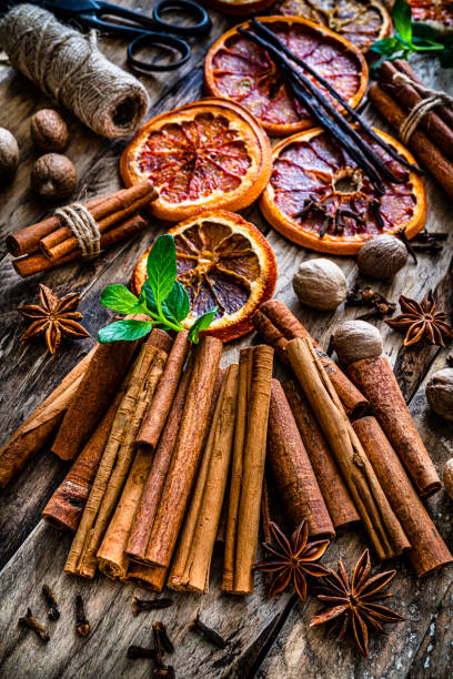 istock Scented spices: cinnamon sticks, nutmeg, star anise, dried oranges and cloves on rustic table 1257728349