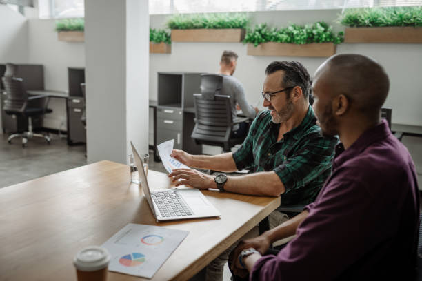 istock To diverse businessmen working together at a table in an office 1257729259
