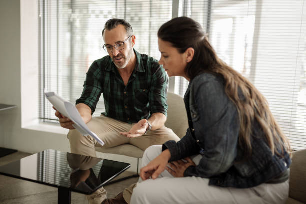 istock Mature businesspeople going over paperwork in an office lounge 1257729302