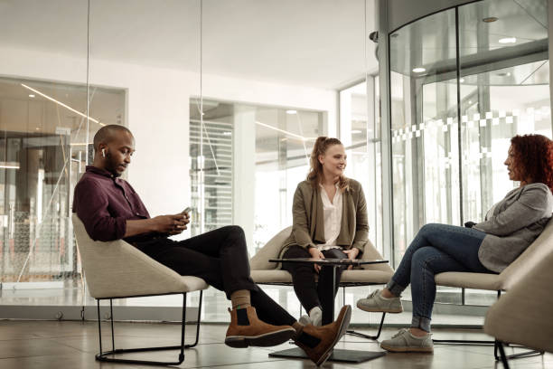 istock Businesspeople sitting in an office lounge during an office break 1257729338