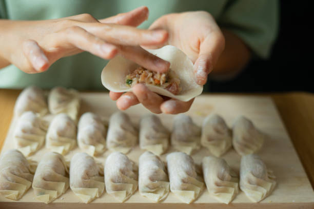 Making Chinese style dumplings homemade Making Chinese style dumplings homemade dumpling stock pictures, royalty-free photos & images