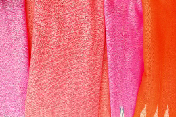 multicolored terry towels, rolled up and stacked on the table