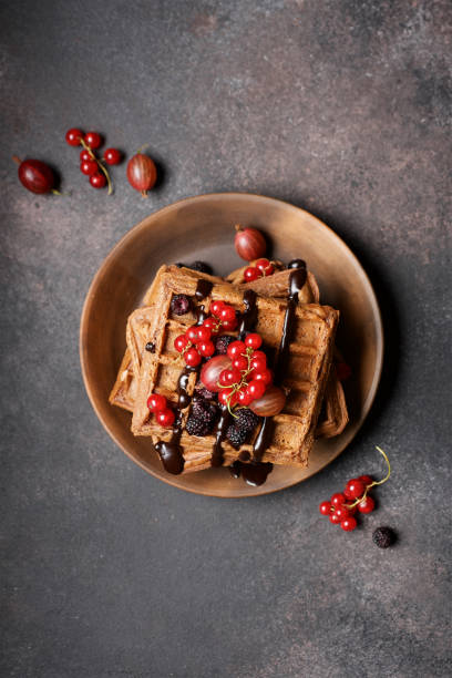 istock Chocolate Belgian waffles with berries.  Baking brown background 1257732889